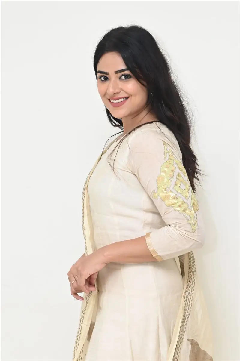 Telugu Actress Priyanka Sharma Smiling Stills in White Dress